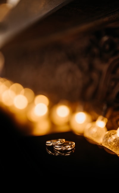 Brown wooden table lit candles
